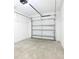 Clean and spacious garage featuring a metal door and concrete floor at 7270 Deer Valley Cir, Tampa, FL 33635