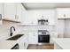 Contemporary kitchen featuring white cabinets, stainless steel appliances, and sleek countertops at 7270 Deer Valley Cir, Tampa, FL 33635