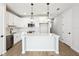 Modern kitchen with stainless appliances, white cabinets and a center island at 7270 Deer Valley Cir, Tampa, FL 33635