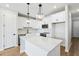 Bright kitchen with white cabinets, stainless steel appliances, and large center island with elegant pendant lighting at 7270 Deer Valley Cir, Tampa, FL 33635