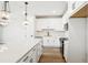 Modern kitchen featuring white cabinets, stainless steel appliances, large island with breakfast bar, and stylish pendant lights at 7270 Deer Valley Cir, Tampa, FL 33635