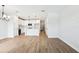 Open-concept living area with wood-look tile flooring and kitchen view at 7270 Deer Valley Cir, Tampa, FL 33635