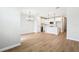 Open-concept living area with wood-look tile flooring and kitchen view at 7270 Deer Valley Cir, Tampa, FL 33635