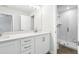 Modern bathroom features double vanity, quartz countertops, brushed nickel hardware, and glass enclosed walk-in shower at 7272 Deer Valley Circle, Tampa, FL 33635