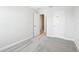 This is a bedroom with neutral walls, a gray carpet and a white door at 7272 Deer Valley Circle, Tampa, FL 33635