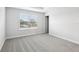 A bright bedroom featuring neutral carpet, a large window with blinds, and modern minimalist design at 7272 Deer Valley Circle, Tampa, FL 33635