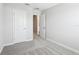 This is a bedroom with neutral walls, a gray carpet and a white door at 7272 Deer Valley Circle, Tampa, FL 33635