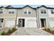 Charming townhouse featuring a paver driveway and attached one-car garage at 7272 Deer Valley Circle, Tampa, FL 33635