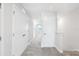 Bright hallway with neutral carpet, linen closet, and white doors, showcasing clean lines and simple design at 7272 Deer Valley Circle, Tampa, FL 33635
