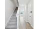 Bright hallway with wood-look tile flooring and carpeted stairs leading to the upper level at 7272 Deer Valley Circle, Tampa, FL 33635