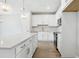 Open kitchen design showcasing a large island, modern appliances, and sleek white cabinetry with stylish hardware at 7272 Deer Valley Circle, Tampa, FL 33635