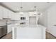 Bright, modern kitchen with white cabinets, tile backsplash, and a center island at 7272 Deer Valley Circle, Tampa, FL 33635