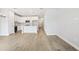 Open-concept living area with tile floors, white kitchen, and island with pendant lighting at 7272 Deer Valley Circle, Tampa, FL 33635