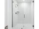 Contemporary walk-in shower with glass door, white subway tile, rainfall shower head, and built-in shelf at 7272 Deer Valley Circle, Tampa, FL 33635
