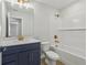 Modern bathroom featuring a navy blue vanity, white subway tile, and gold hardware at 7274 Deer Valley Cir, Tampa, FL 33635