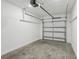 Clean garage featuring concrete floor, white walls, and a closed garage door with opener at 7274 Deer Valley Cir, Tampa, FL 33635