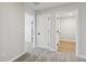 Hallway featuring carpeted floor and white doors leading to other rooms at 7274 Deer Valley Cir, Tampa, FL 33635
