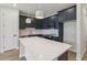 Modern kitchen featuring navy cabinets, white countertops, stainless steel appliances, and chevron backsplash at 7274 Deer Valley Cir, Tampa, FL 33635