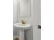 Powder room featuring pedestal sink with gold fixtures and hardware plus a frameless mirror at 7274 Deer Valley Cir, Tampa, FL 33635