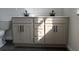 Elegant bathroom featuring a double sink vanity with granite countertops and stylish dark hardware, plus ample storage at 7284 Deer Valley Cir, Tampa, FL 33635