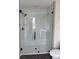 Modern bathroom features a glass-enclosed shower with white subway tile, complemented by sleek fixtures and a neutral color scheme at 7284 Deer Valley Cir, Tampa, FL 33635