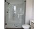 Elegant shower with frameless glass enclosure and white subway tile, offering a serene and modern bathing experience at 7284 Deer Valley Cir, Tampa, FL 33635