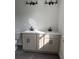 Modern bathroom featuring a double sink vanity with granite countertops and black fixtures, complemented by sleek lighting at 7284 Deer Valley Cir, Tampa, FL 33635