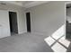 Spacious unfinished bedroom features a neutral color palette, with multiple doorways leading to other rooms at 7284 Deer Valley Cir, Tampa, FL 33635
