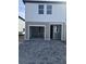 Modern two-story townhome featuring an attached garage and a neatly paved driveway at 7284 Deer Valley Cir, Tampa, FL 33635
