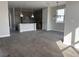 Open concept living room and kitchen featuring gray wood-look tile and a modern light fixture at 7284 Deer Valley Cir, Tampa, FL 33635