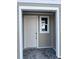 Charming porch featuring a well-lit entryway with a door and window at 7284 Deer Valley Cir, Tampa, FL 33635