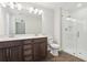 Modern bathroom with a double vanity, glass-enclosed shower, and tile flooring at 7294 Deer Valley Cir, Tampa, FL 33635