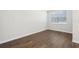 Bright, minimalist bedroom with wood-look floors and a window at 7294 Deer Valley Cir, Tampa, FL 33635