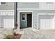 Close up of townhome entrance featuring a dark front door and paved pathway at 7294 Deer Valley Cir, Tampa, FL 33635