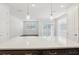 Modern kitchen with white countertops and stainless steel appliances open to living area at 7294 Deer Valley Cir, Tampa, FL 33635