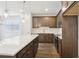 A bright kitchen featuring an island, dark cabinets, stainless steel appliances, and tile floors at 7294 Deer Valley Cir, Tampa, FL 33635
