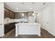 Modern kitchen with dark wood cabinets, white countertop island, and stainless steel appliances at 7294 Deer Valley Cir, Tampa, FL 33635