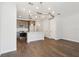 Open-concept kitchen and living space featuring wood-look floors and ample lighting at 7294 Deer Valley Cir, Tampa, FL 33635