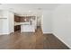 Open-concept living space with wood-look floors flowing into the kitchen and dining area at 7294 Deer Valley Cir, Tampa, FL 33635