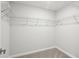 Empty walk-in closet with carpeted floor and wire shelving at 7294 Deer Valley Cir, Tampa, FL 33635