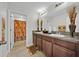 Well-lit bathroom with double sinks, granite countertops, and a shower/tub combo at 10607 Standing Stone Drive, Wimauma, FL 33598