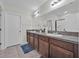 Bathroom featuring double sinks, granite countertops, and a shower at 10607 Standing Stone Drive, Wimauma, FL 33598