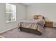 Bedroom with a queen bed, carpeted floors, and window with blinds at 10607 Standing Stone Drive, Wimauma, FL 33598
