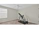 Bedroom with a large window and exercise equipment at 10607 Standing Stone Drive, Wimauma, FL 33598