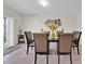 Bright dining room featuring a modern chandelier and decorative wall art at 10607 Standing Stone Drive, Wimauma, FL 33598