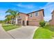 Attractive two-story home with a well-manicured lawn and a convenient two-car garage at 10607 Standing Stone Drive, Wimauma, FL 33598