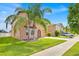 Well-maintained two-story home with lush landscaping and a spacious driveway at 10607 Standing Stone Drive, Wimauma, FL 33598
