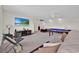 Spacious game room features a pool table, large TV, and comfortable seating for entertainment at 10607 Standing Stone Drive, Wimauma, FL 33598