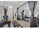 Spacious home gym featuring modern exercise equipment and neutral decor at 10607 Standing Stone Drive, Wimauma, FL 33598