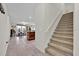 Hallway showcasing open concept layout into living room, kitchen, and dining areas, with stairway visible at 10607 Standing Stone Drive, Wimauma, FL 33598